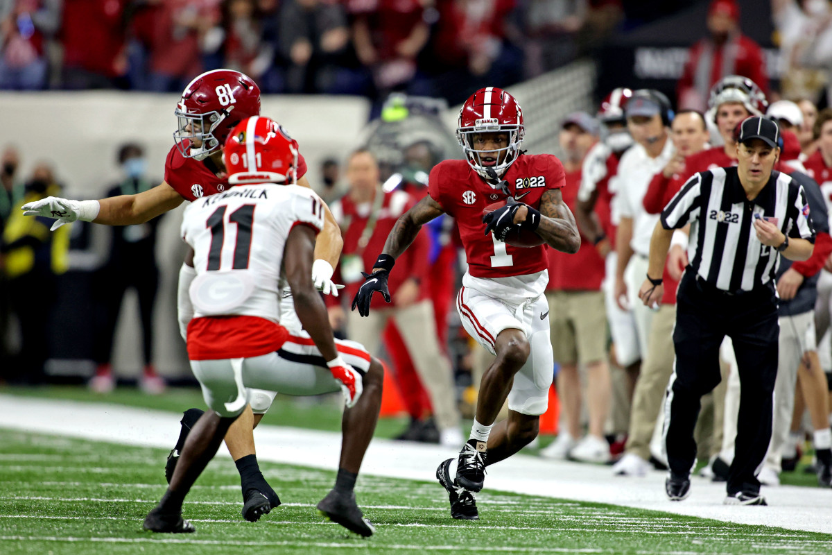 Jan 10, 2022; Indianapolis, IN, USA; Alabama Crimson Tide wide receiver Jameson Williams (1) runs the ball against Georgia Bulldogs defensive back Derion Kendrick (11) during the first quarter in the 2022 CFP college football national championship game at Lucas Oil Stadium. Mandatory Credit: Trevor Ruszkowski-USA TODAY Sports